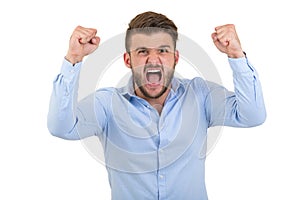 Image of screaming angry young bearded emotional man standing over white wall background isolated.