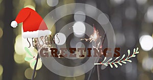 Image of seasons greetings text over lit sparklers background