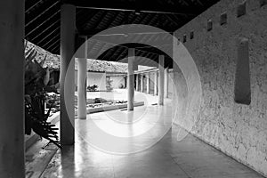 Image of semi outdoor corridor show rhythm of row columns, space flow and outdoor open space connection imply peaceful Bali style