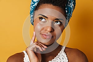 Image of serious african american woman thinking and looking upward