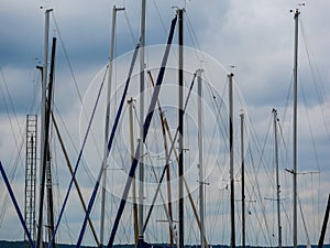 Image of several ship mast in the sky