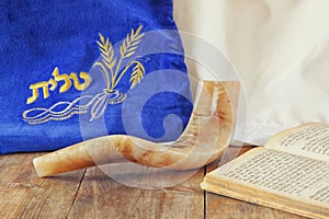 Image of shofar (horn) and prayer case with word talit (prayer) writen on it