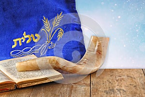 Image of shofar (horn) and prayer case with word talit (prayer) writen on it