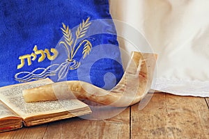 Image of shofar (horn) and prayer case with word talit (prayer) writen on it. room for text. rosh hashanah (jewish holiday) photo