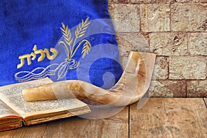 Image of shofar (horn) and prayer case with word talit (prayer) writen on it. room for text. rosh hashanah (jewish holiday) photo