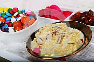 kheer. rice pudding. syrian rice pudding with colorful candies and flower petals.