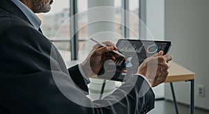 Businessman Analyzing Data on Tablet