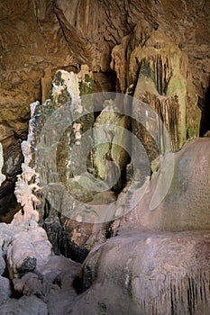 This image showcases a cave interior with intricate stalactite and stalagmite formations. photo