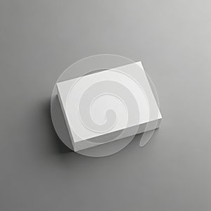 A clean white rectangular box rests on a neutral gray surface in a studio setting