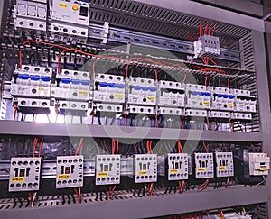 Image shows circuit breakers and electrical contactors. Close-up. Modern distribution case. Contorl cubicle