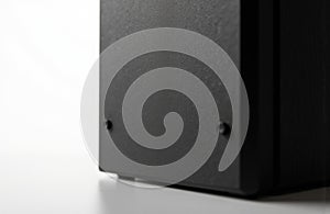 Close-up of a black electronic device with a textured surface on a white