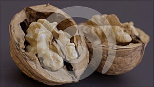 Close-up of walnuts cracked open on dark background - AI generated
