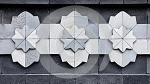 A wall with a repeating pattern of white and gray tiles.