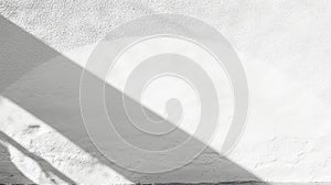 A white wall with a shadow cast by a light source.