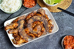 The image shows delicious chicken wings coated with a golden soy-honey sauce glaze. photo