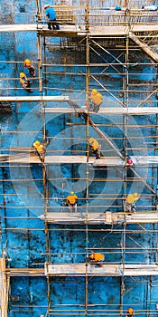 Construction workers collaborating on scaffolding