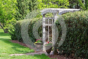 Arched wooden arbor trellis in a ornamental garden