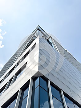 The image shows a modern high-rise building with a sleek