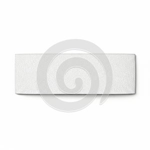 A close-up view of a textured white rectangular object on a white background