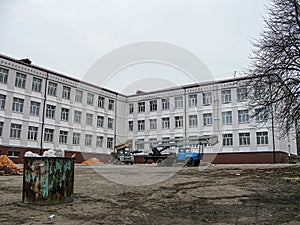 Image shows a renovationconstruction site of an old school or institutional building, with construction materials and