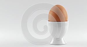 a single brown egg in a white egg cup on a plain background - generated using ai