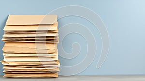 A stack of papers on a blue wall.