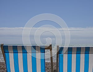 Brighton, England, the UK - beach chairs and blue skies.