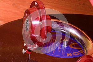 Image shows vintage gramophone famous Czech brand Supraphone. The red wind-up gramophone and vinyl record brand Ultraphon.