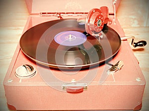 Image shows vintage gramophone famous Czech brand Supraphone. The red wind-up gramophone and vinyl record brand Ultraphon. Ret