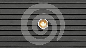 A cup of coffee with latte art on the surface.