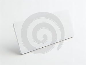 A sleek and modern white rectangular object with a smooth surface and rounded edges