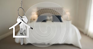 Image of silver house keys and house shaped key fob hanging over an out of focus bedroom 4k