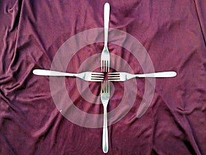 Simple set of fork and  isolated on violet background.