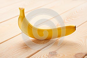 Image of single Banana on wooden table