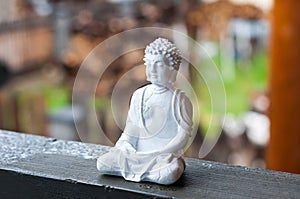 Image of sitting Buddha on blurred background. Meditation concept