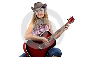 Image of sitting cowgirl with the guitar