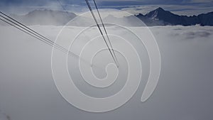 Image of ski gondola ropes who disappear in the fog