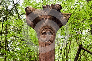 The image of the Slavic deity Veles carved from root of a tree on a neo-Pagan temple in the forest