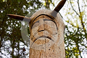 The image of the Slavic deity Veles carved from a tree trunk on a neo-Pagan temple in the forest