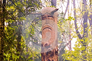 The image of the Slavic deity Veles carved from a tree trunk on a neo-Pagan temple in the forest