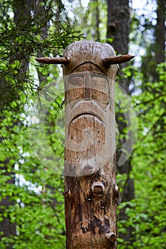 Image of the Slavic deity Veles carved from a tree trunk on a neo-Pagan temple in the forest