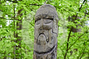 The image of the Slavic deity Veles carved from a tree trunk on a neo-Pagan temple in the forest