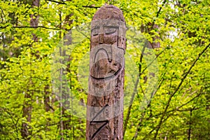 The image of the Slavic deity Veles carved from a tree trunk on a neo-Pagan temple in the forest