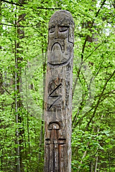 The image of the Slavic deity Veles carved from a tree trunk on a neo-Pagan temple in the forest