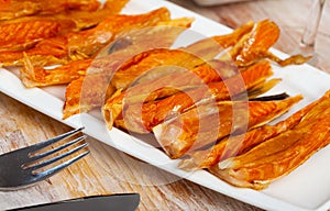 Image of slices of smoked salmon belly at plate