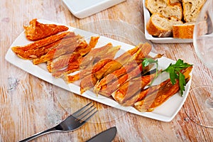 Image of slices of smoked salmon belly at plate