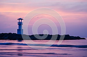 Image of small lighthouse against a tropical ocean sunset and smooth water at Khao Lak Beach in Phang Nga,Thailand.