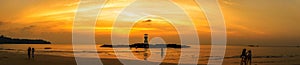 Image of small lighthouse against a tropical ocean sunset and smooth water at Khao Lak Beach in Phang Nga,Thailand.