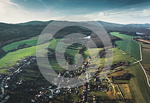 Image of small village in Slovakia - Europe with two big lakes and big mountains hills on background. Hilly Village with green