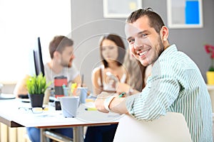 Image of smart young businessmen looking at camera